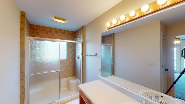 bathroom with ceiling fan, vanity, and a shower with shower door