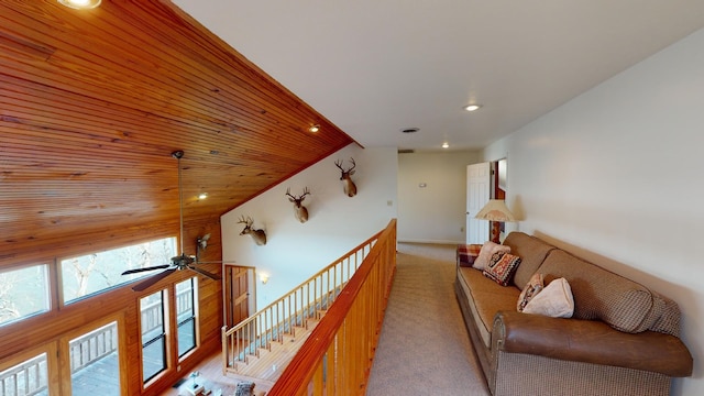 hallway featuring light colored carpet, wood ceiling, and vaulted ceiling