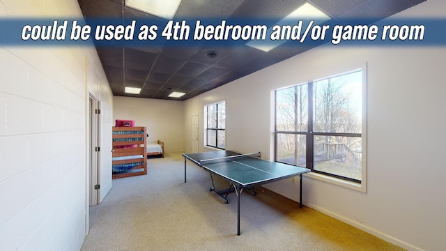 playroom with carpet flooring and a paneled ceiling