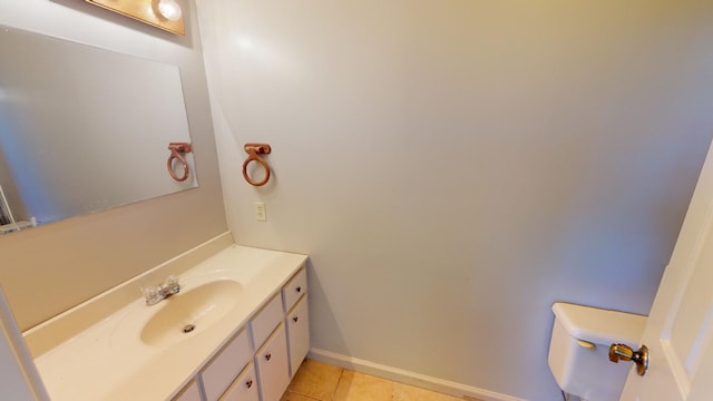 bathroom with tile patterned flooring, vanity, and toilet