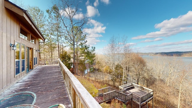 wooden terrace featuring a water view