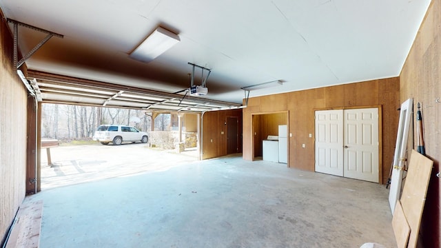 garage featuring a garage door opener and washing machine and clothes dryer