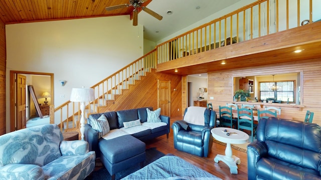 living room featuring high vaulted ceiling, wooden ceiling, ceiling fan with notable chandelier, and hardwood / wood-style flooring