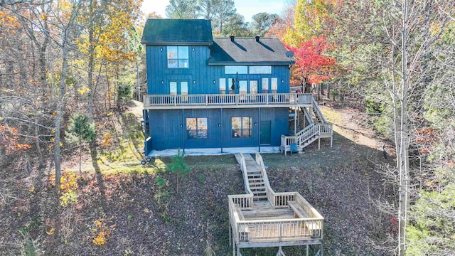 rear view of property featuring a patio area and a wooden deck