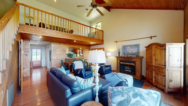 living room featuring hardwood / wood-style flooring, high vaulted ceiling, ceiling fan, and wooden ceiling