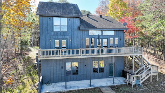 rear view of property with a deck, a patio, and french doors