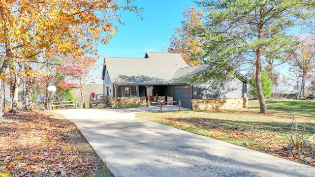 view of front of home with a garage and a front lawn