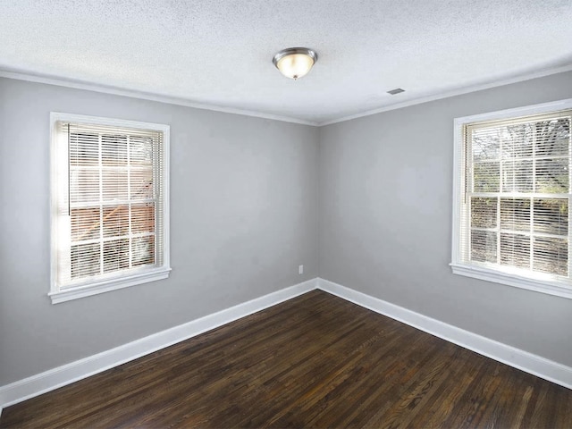 spare room featuring a textured ceiling and dark wood-type flooring