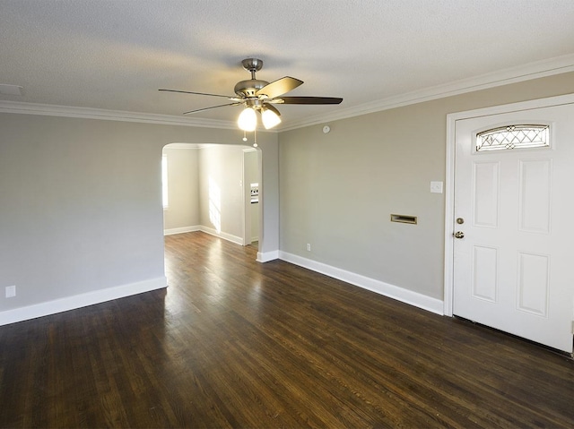 foyer entrance featuring a textured ceiling, ornamental molding, dark hardwood / wood-style flooring, and ceiling fan