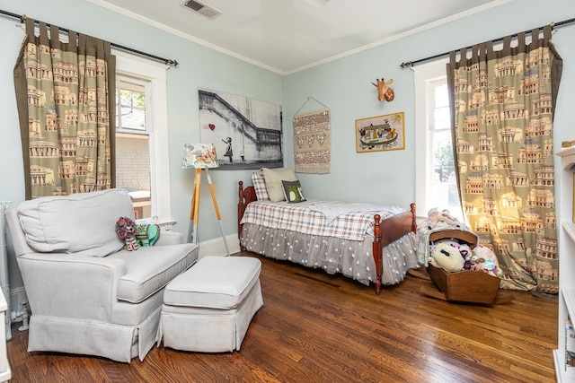 bedroom with ornamental molding and dark wood-type flooring