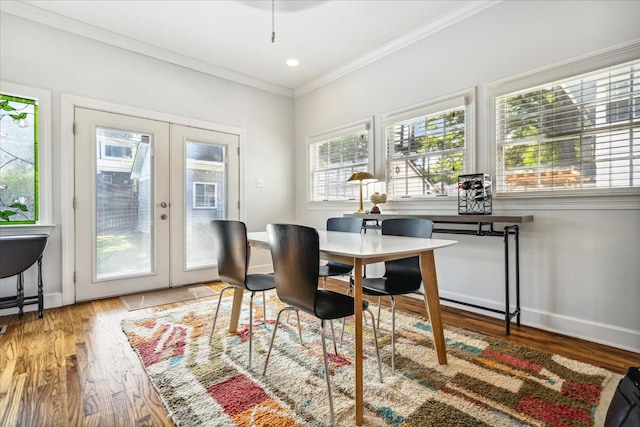 dining room with french doors, hardwood / wood-style flooring, and ornamental molding