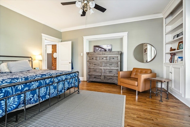 bedroom with ceiling fan, hardwood / wood-style flooring, and crown molding