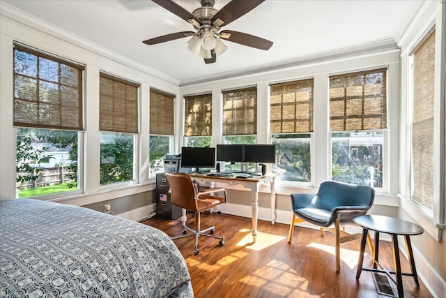 bedroom featuring multiple windows, crown molding, ceiling fan, and hardwood / wood-style flooring