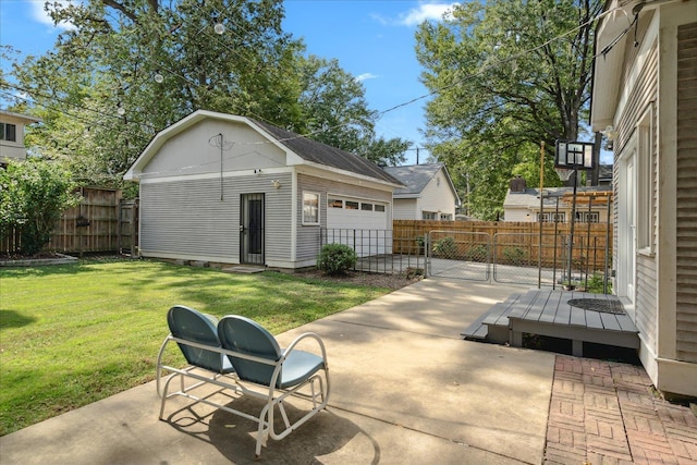 view of patio / terrace featuring an outdoor structure, fence, and a detached garage