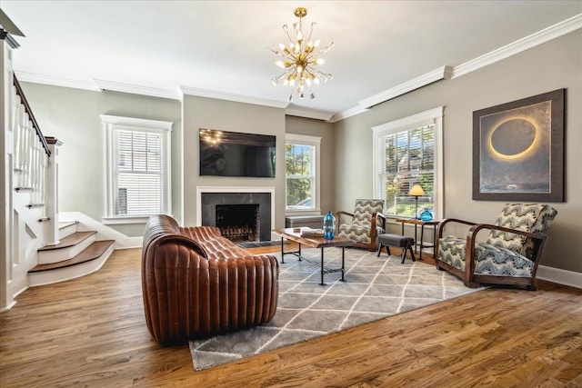 living room featuring ornamental molding, a notable chandelier, and hardwood / wood-style floors