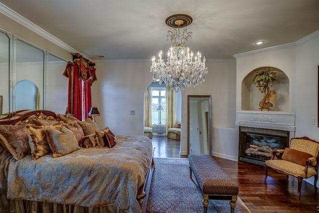 bedroom featuring ornamental molding, a notable chandelier, and dark hardwood / wood-style flooring