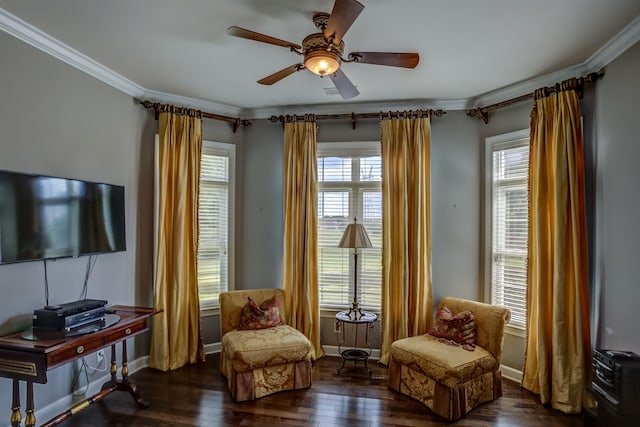 sitting room with ceiling fan, crown molding, and dark wood-type flooring