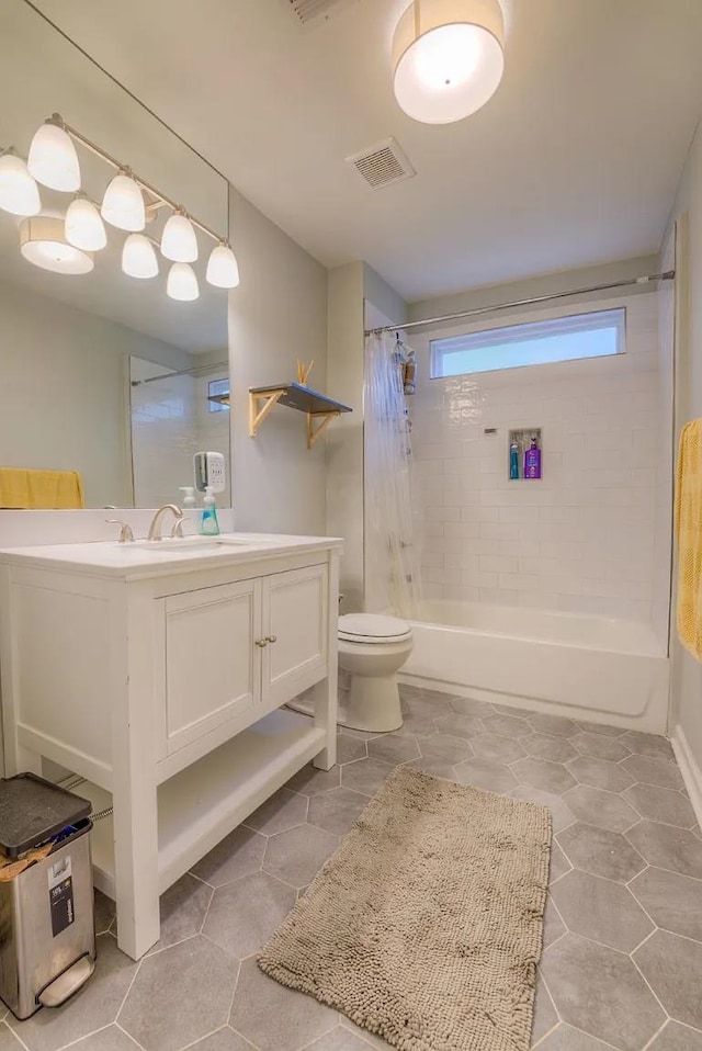 full bathroom featuring shower / bathtub combination with curtain, tile patterned flooring, vanity, and toilet