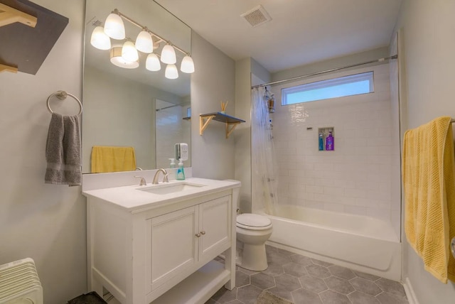 full bathroom with tile patterned flooring, shower / bath combo, vanity, and toilet