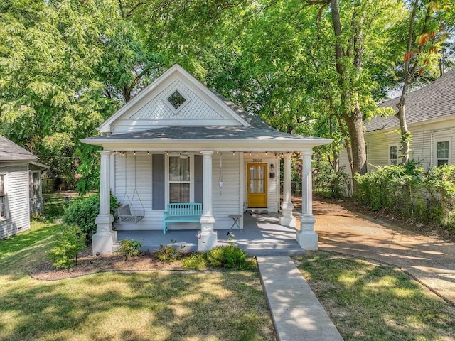 bungalow-style house featuring a front lawn and covered porch