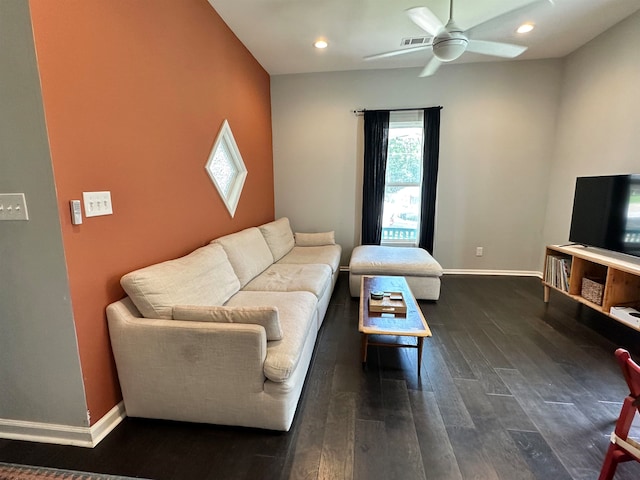 living room with ceiling fan and dark wood-type flooring