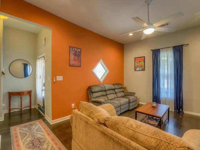 living room featuring dark hardwood / wood-style floors and ceiling fan