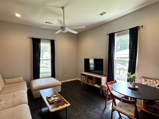 living room with ceiling fan and dark wood-type flooring