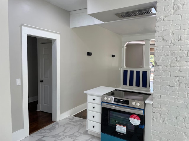 kitchen featuring light hardwood / wood-style floors, stainless steel electric stove, and white cabinetry