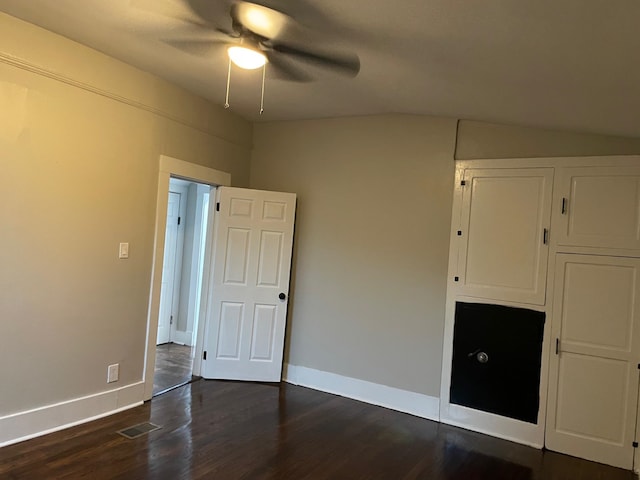 unfurnished bedroom with lofted ceiling, ceiling fan, and dark hardwood / wood-style floors