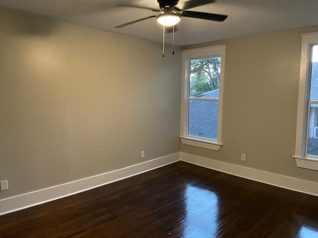 spare room with ceiling fan and dark hardwood / wood-style floors