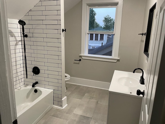 full bathroom with vanity, toilet, vaulted ceiling, and tiled shower / bath