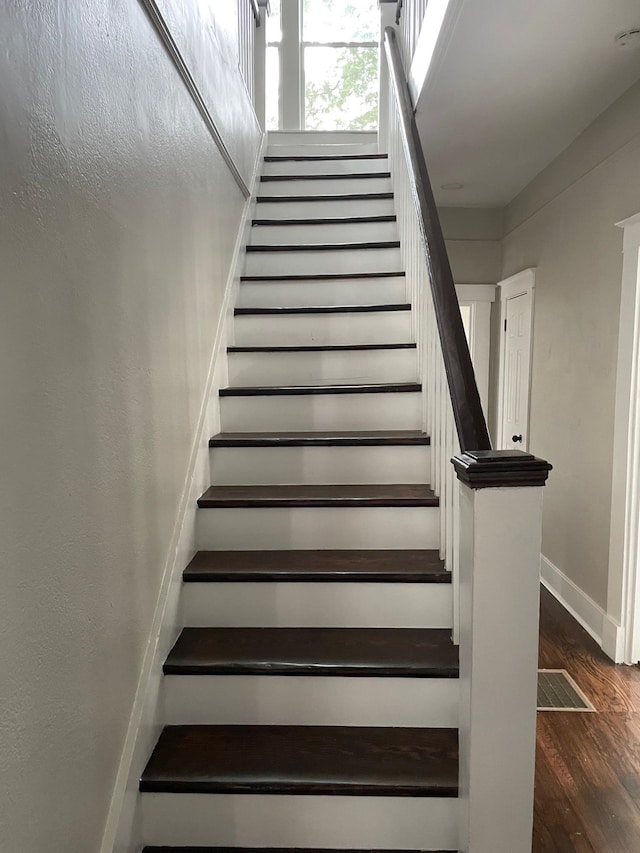 staircase with wood-type flooring