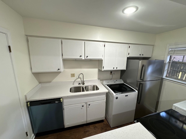 kitchen featuring washer / dryer, appliances with stainless steel finishes, white cabinetry, and sink