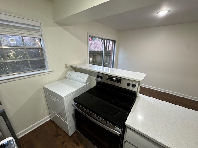 washroom with washer / clothes dryer and dark hardwood / wood-style floors