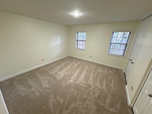 carpeted spare room with a healthy amount of sunlight