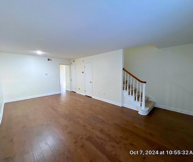 unfurnished room featuring dark wood-type flooring