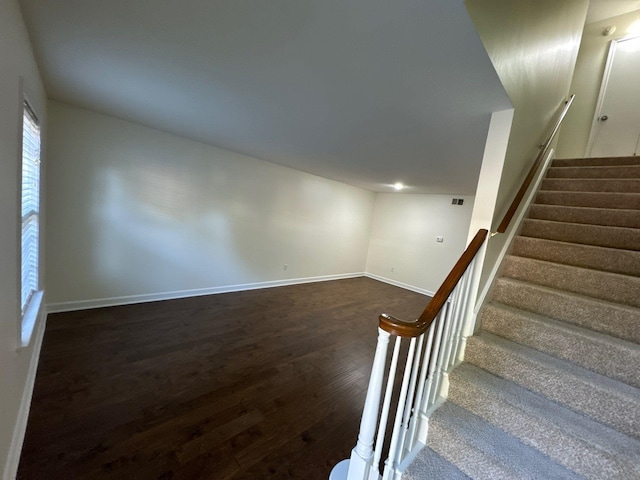 stairs featuring hardwood / wood-style floors