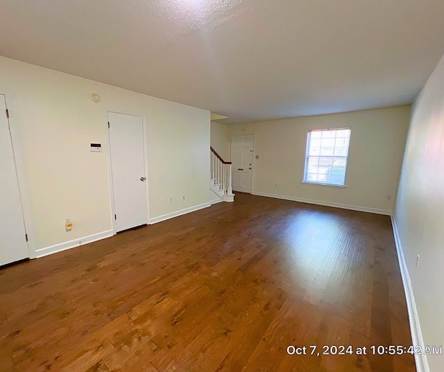 empty room with dark hardwood / wood-style flooring