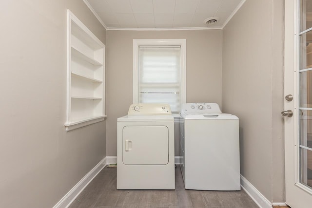 laundry room with washer and clothes dryer, hardwood / wood-style floors, and crown molding