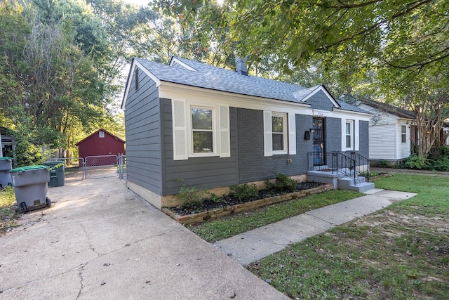 bungalow-style home with a front lawn