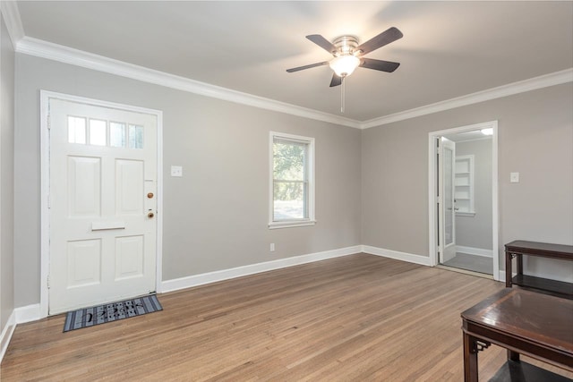 entrance foyer with ceiling fan, hardwood / wood-style flooring, and ornamental molding