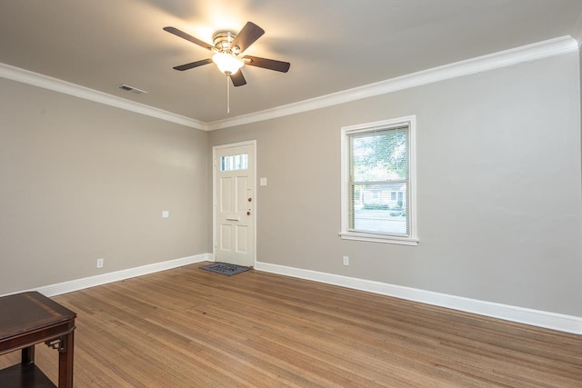 entrance foyer featuring wood-type flooring, ornamental molding, and ceiling fan