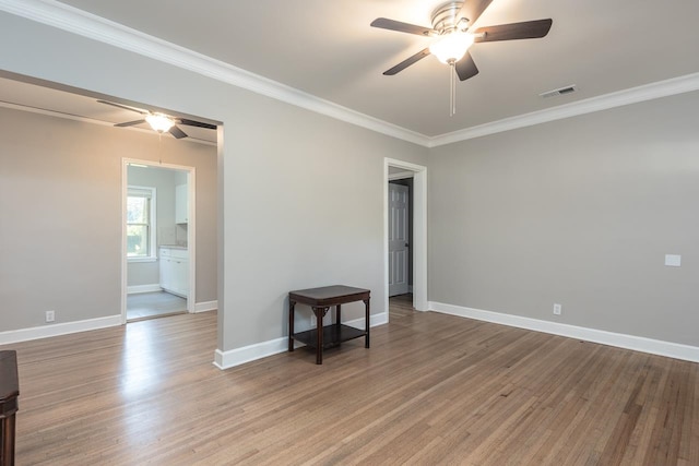 unfurnished room featuring ornamental molding, ceiling fan, and hardwood / wood-style flooring