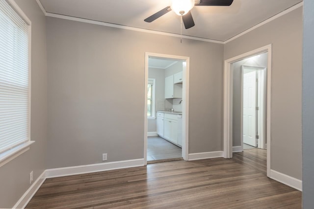 spare room featuring wood-type flooring, ornamental molding, and ceiling fan