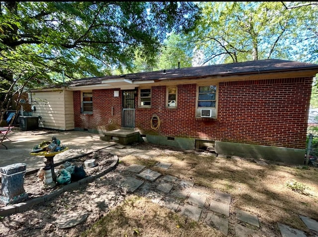 rear view of property featuring central AC unit, cooling unit, and a patio