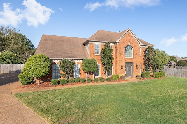 colonial-style house with a front yard