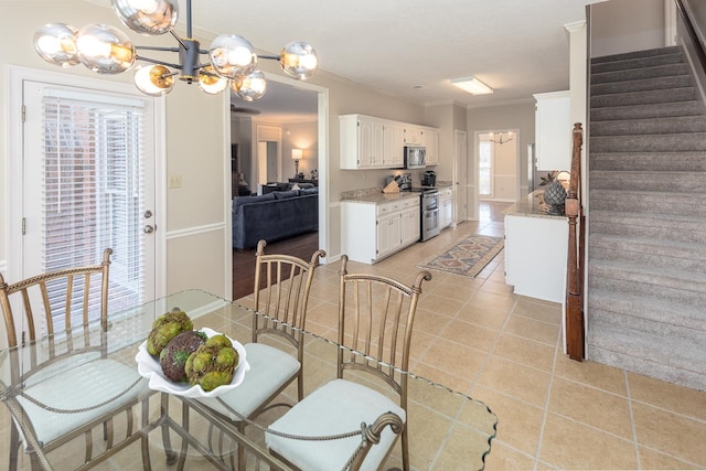 dining area with light tile patterned flooring, a wealth of natural light, and ornamental molding