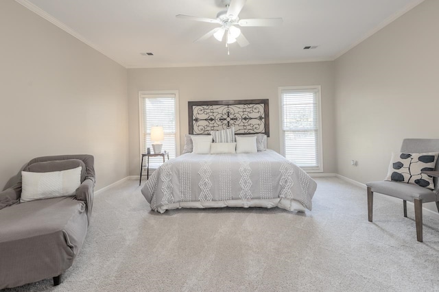 carpeted bedroom with multiple windows, ceiling fan, and crown molding