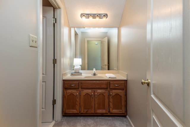 bathroom with vanity and a textured ceiling