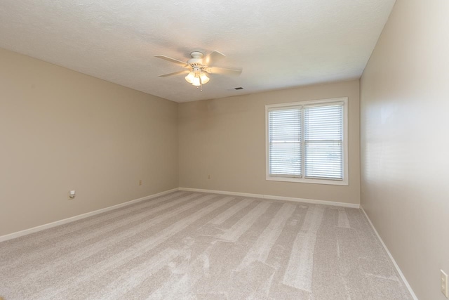 carpeted empty room with a textured ceiling and ceiling fan